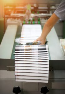 Stack of books hot off the press from InstantPublisher, the premier self-publishing book company