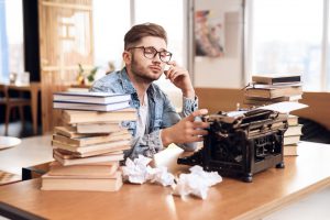 Man writing for a self-publishing book printing project