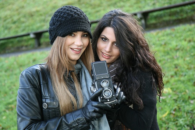 Two self-publishing authors with a historical camera representing their hobby
